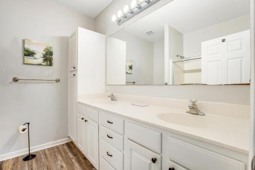 a white bathroom with a sink and a mirror at Sandpiper Village --- 35552 E Atlantic Cir #101 in Rehoboth Beach