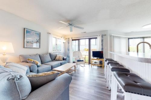 a living room with a blue couch and chairs at East of the Sun --- 40026 E Sun Dr Unit 611 in Fenwick Island