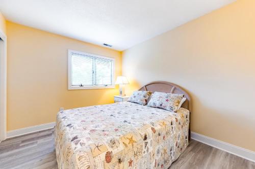 a bedroom with a bed and a window at East of the Sun --- 40026 E Sun Dr Unit 611 in Fenwick Island