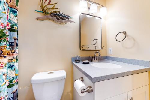 a bathroom with a toilet and a sink and a mirror at East of the Sun --- 40026 E Sun Dr Unit 611 in Fenwick Island