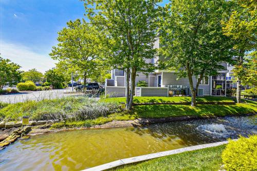 a house with a pond in front of a house at East of the Sun --- 40026 E Sun Dr Unit 611 in Fenwick Island
