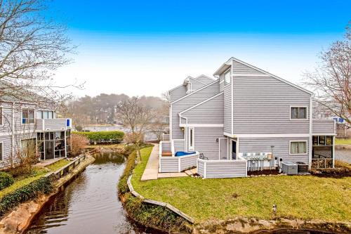 a large house with a river in front of it at East of the Sun --- 40026 E Sun Dr Unit 611 in Fenwick Island