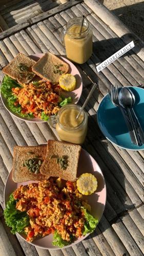 twee borden eten op een houten tafel bij Colorful Hut in Haad Pleayleam