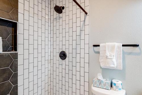 a bathroom with a shower with a toilet and towels at Sugar Reef Cottage-356 Billfish unit #1 in Fort Walton Beach