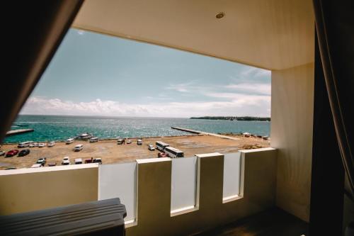 a view of the ocean from a room with a window at Navarro Hotel in Caticlan