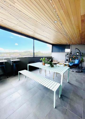 a table and benches in a room with a view at 734 apartment-2 bedroom and 2 bathroom accommodation, sleeps 4 in Margaret River Town
