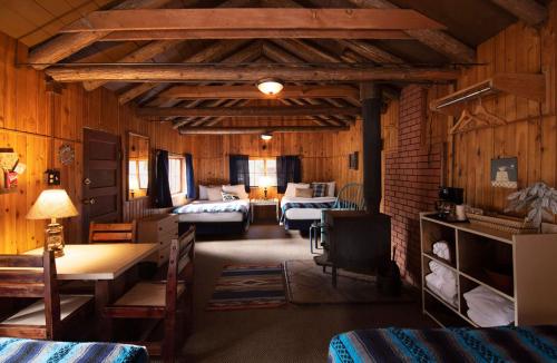 a room with two beds and a living room at Lochsa Lodge in Lolo