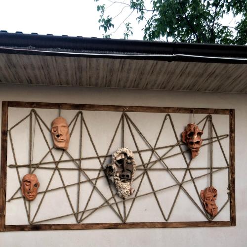 a group of skulls and masks on a wall at Village Jazz in Chimankend