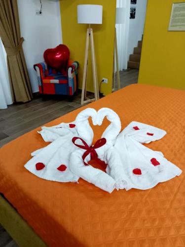 two towels in the shape of a swan on a bed at Centro Storico in Pozzuoli