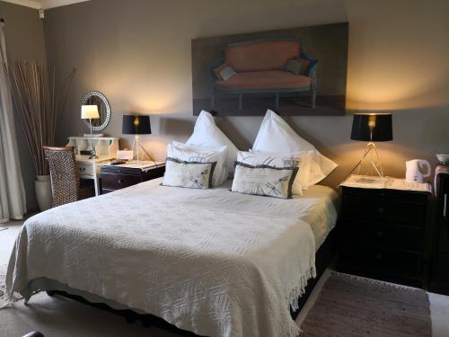 Un pat sau paturi într-o cameră la Perle Du Cap