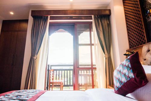 a bedroom with a bed and a window with a view at Everest Boutique Hotel in Kathmandu