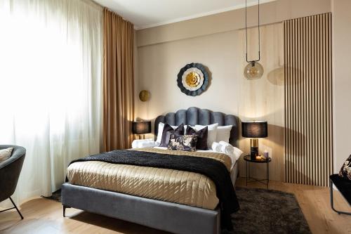 a bedroom with a large bed with a blue headboard at Qult - Dune in Bucharest