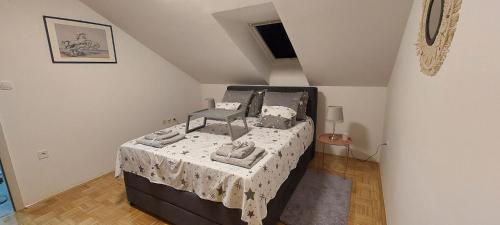 a bedroom with a large bed in a attic at DITA Osijek, centar grada in Osijek