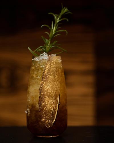 a gold vase with a plant in it at Hotel Monopol in Katowice