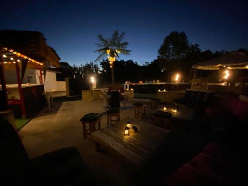 a rooftop patio at night with a table and chairs at Villa Sainte Barbe in Mirecourt
