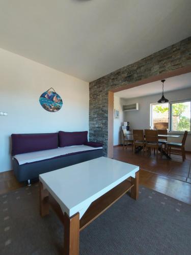 a living room with a couch and a table at Apartment Maskarin Rab in Mundanije