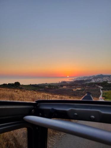 a view of the sunset from a vehicle at Villa Marna Bianca in Borgo Bonsignore