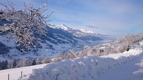 a snow covered road with a mountain in the background at Hüttenzauber in Taxenbach