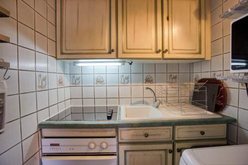 a small kitchen with a sink and a stove at Oiseau de Feu in Villarembert