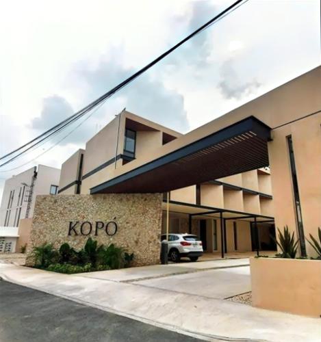 a kroop building with a car parked in front of it at New & beautiful apartment GF with private pool in Mérida