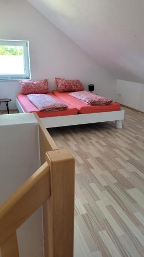 a bedroom with two beds and a wooden floor at Schöne Maisonette Düren in Düren - Eifel