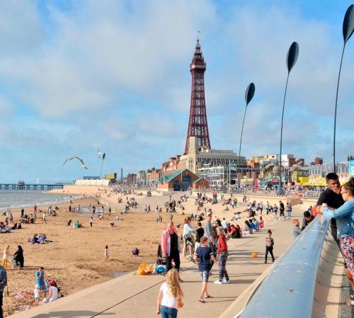 a group of people on the beach with the eiffel tower at Blackpool Central Apartments 2 Bedroom FF in Blackpool