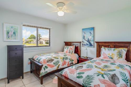 a bedroom with two beds and a ceiling fan at Mango House in Naples
