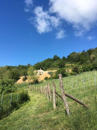 a wooden fence in a field next to a hill at Ca`Rosei in Monteciccardo