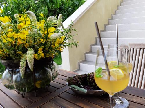 a table with two glasses of orange juice and flowers at Ca`Rosei in Monteciccardo