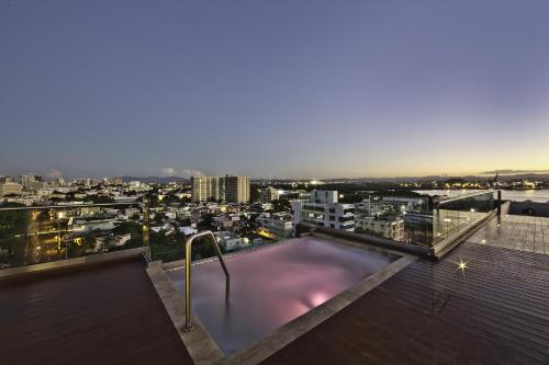 a swimming pool on the roof of a building at Ciqala Luxury Suites - San Juan in San Juan