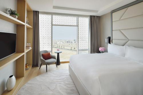 a bedroom with a large bed and a large window at Crowne Plaza - Jeddah Al Salam by IHG in Jeddah