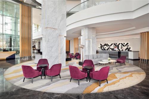 a lobby with pink chairs and a couch at Crowne Plaza - Jeddah Al Salam, an IHG Hotel in Jeddah