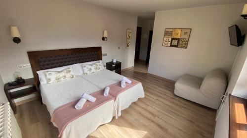 a bedroom with a bed with two dolls on it at Hotel La Cuna del Sella in Oseja de Sajambre