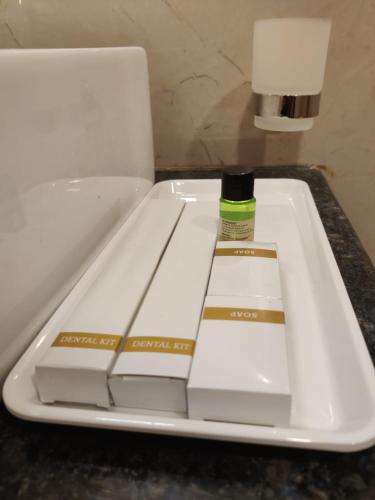 a white tray with a bottle of glue on it at Relax Inn in Bengaluru