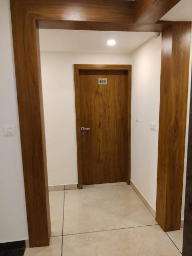 a hallway with a wooden door in a room at Relax Inn in Bengaluru