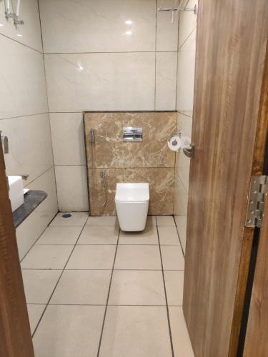 a bathroom with a toilet and a sink at Relax Inn in Bengaluru