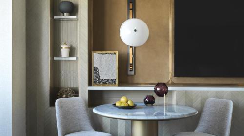 a dining room with a table and two chairs at Four Seasons Hotel Riyadh in Riyadh