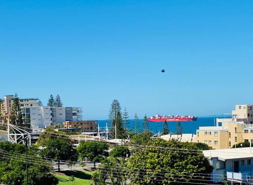 ein Blick auf eine Stadt mit dem Meer im Hintergrund in der Unterkunft Ocean Views & Rooftop on Saltair - Kings Beach in Caloundra