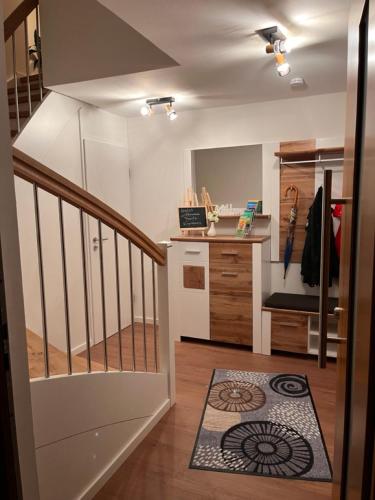 a room with a staircase and a kitchen with a counter at bike & chill in Kleve