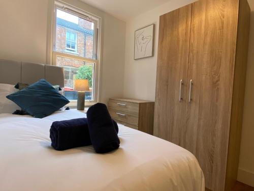a bedroom with a bed and a wooden cabinet at De Parys Self-Catering Flat 2 in Bedford in Bedford