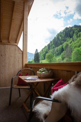a room with a table and a view of a mountain at Brunnenhof Oberstdorf - Ferienwohnungen mit Hotel Service in Oberstdorf