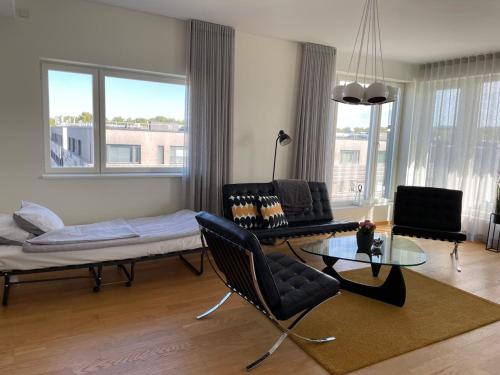 a living room with a couch and a table at Penthouse Kadriorg in Tallinn