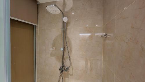 a shower with a shower head in a bathroom at Apartment Cam Ranh in Thôn Hòa Ða