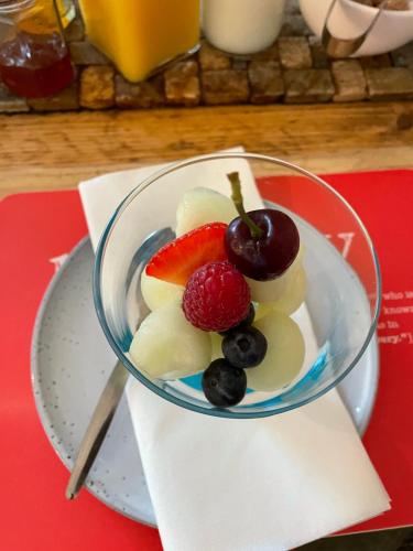 a bowl of fruit on a plate on a table at Gowanlea Guest House in Balloch