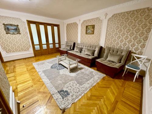 a living room with a couch and a table at Classic C1 Apartment In The Center With 4 Rooms in Tashkent