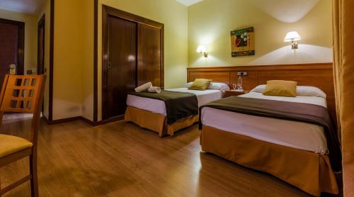 Postel nebo postele na pokoji v ubytování Hotel Zodiaco
