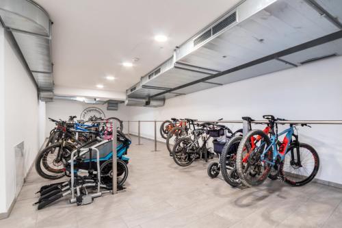 a group of bikes parked in a garage at JUFA Alpenhotel Saalbach-Jokercard im Sommer inklusive in Saalbach Hinterglemm