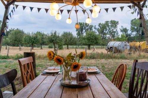 a wooden table with a vase of sunflowers on it at YURs in Baexem