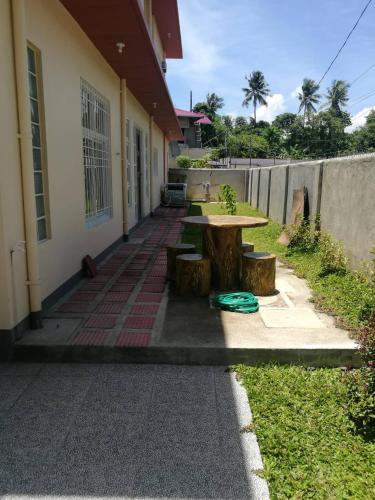 a picnic table in front of a building at Overnight Villa Transient House in Sorsogon