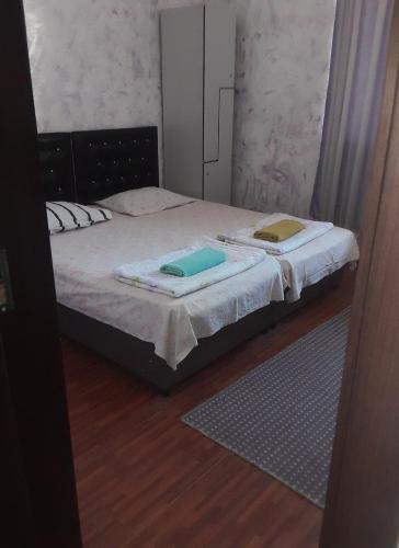 a bedroom with a bed with two towels on it at Guesthouse Qeti in Batumi